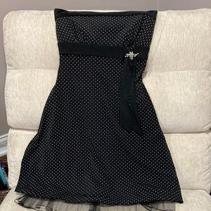 Black and white polka dot cocktail dress with brooch accent and tulle hemline